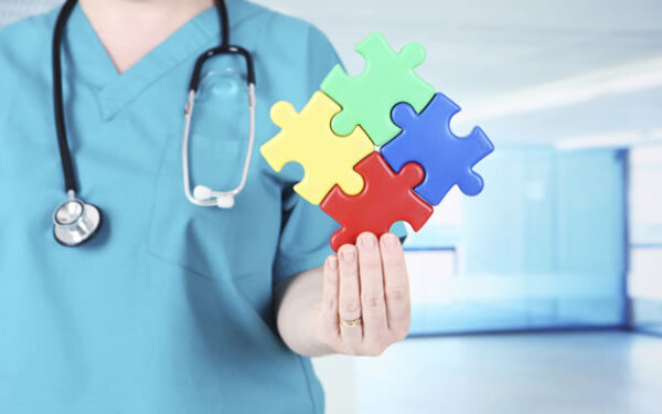 nurse holding multi-color puzzle piece