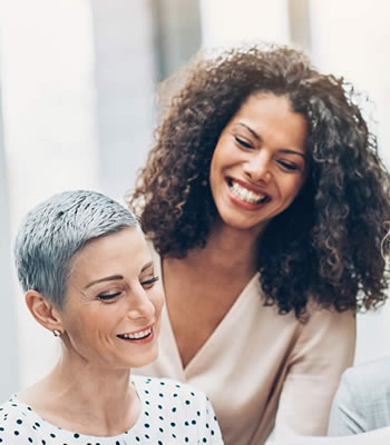 group of people smiling and looking at piece of paper